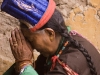 Traditionally dressed Ladakhi woman praying, Hemis Festival.