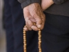 Man holds prayer beads near the Jokhang temple, Lhasa.