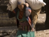 Woman carrying a heavy load in Kagbeni.