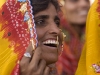 Woman amused by the tug-of-war result while watching the closing ceremonies of Pushkar Camel Fair.